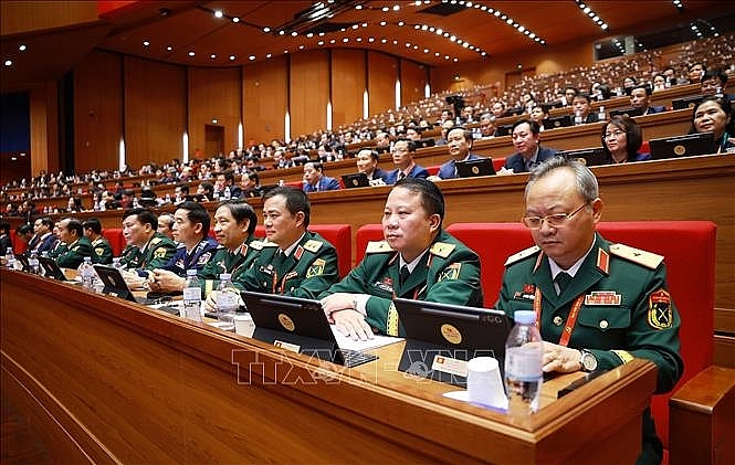 Đoàn đại biểu Đảng bộ Quân đội dự phiên thảo luận tại hội trường về các văn kiện Đại hội chiều 21/1. Ảnh: TTXVN Đoàn đại biểu Đảng bộ Quân đội dự phiên thảo luận tại hội trường về các văn kiện Đại hội chiều 21/1. Ảnh: TTXVN