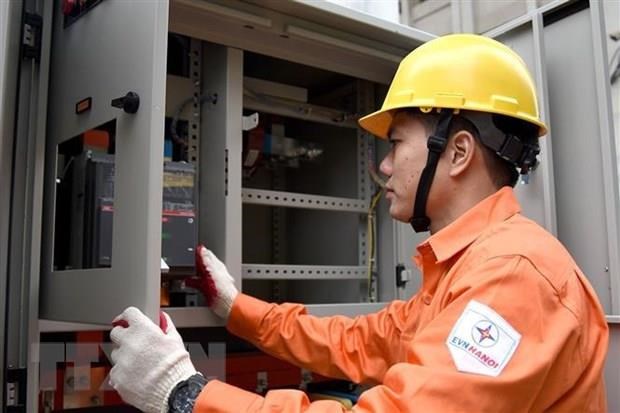 Nh&acirc;n vi&ecirc;n EVN H&agrave; Nội kiểm tra c&ocirc;ng t&aacute;c đảm bảo an to&agrave;n cấp điện. Ảnh: TTXVN.